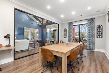 a dining room with a wooden table and chairs